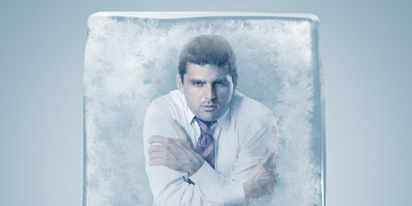 Young man in shirt and tie, frozen in ice cube.