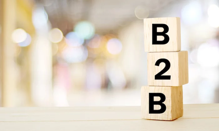Wooden blocks spelling B-2-B against a blurred background.