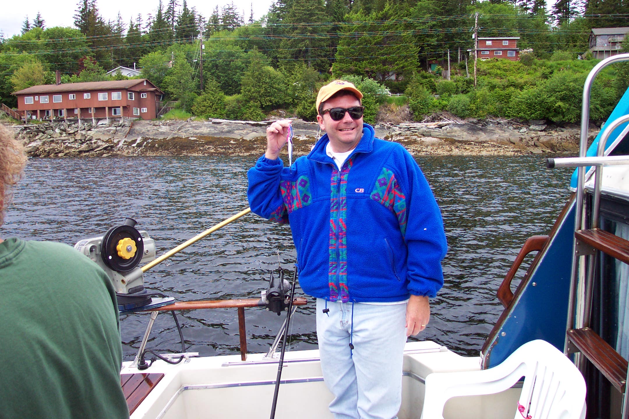 Mike Harris in Alaska showing off tiny fish just caught.